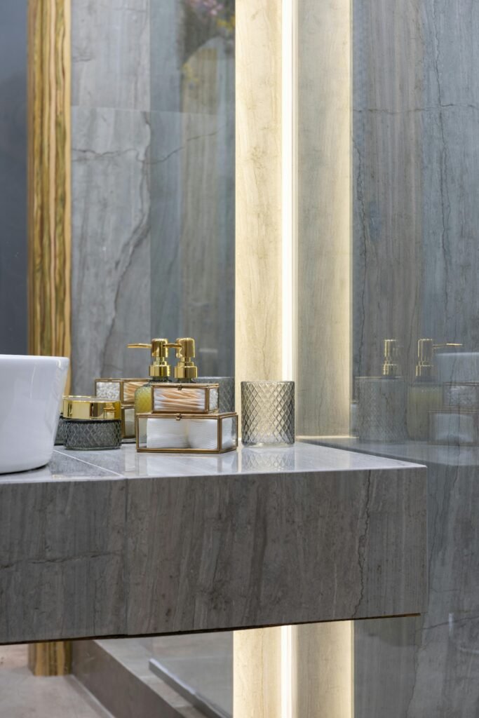 Stylish bathroom counter with elegant toiletries and mirror reflections.